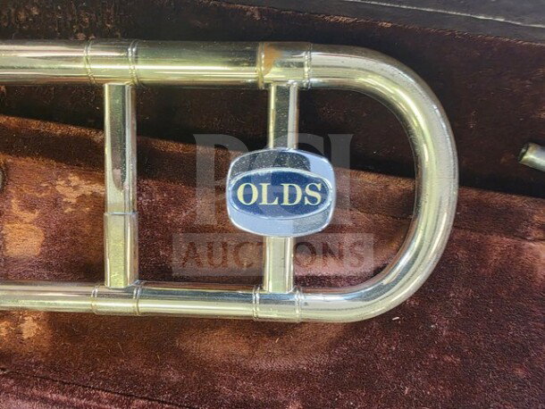 Vintage F.E. Olds Ambassador Student Trombone in brass, with visible "OLDS" logo. Sold as is, showing use, in original case.