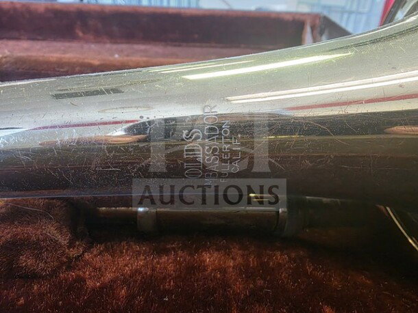 Vintage F.E. Olds Ambassador student trombone with visible surface wear, engraved with "Olds Ambassador Fullerton Calif." Sold as is.