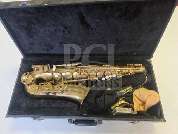 Vintage alto saxophone in worn, original condition within a black velvet-lined case, including mouthpiece and cleaning cloth.