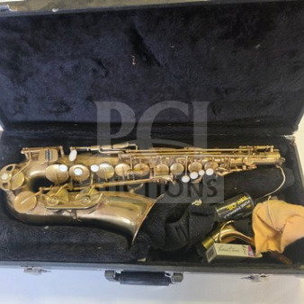 Vintage alto saxophone in worn, original condition within a black velvet-lined case, including mouthpiece and cleaning cloth.