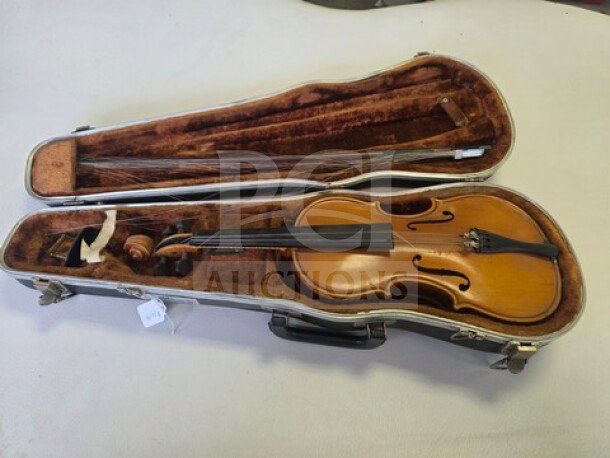 E.R. Pfretzchner violin in a hard case, showing a wooden finish and strings. Sold as is, includes bow and interior storage.