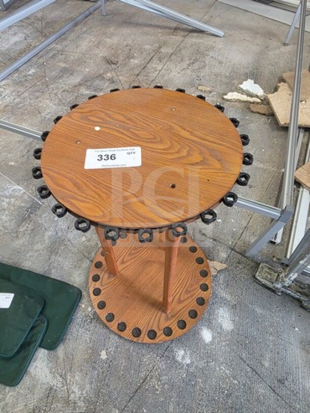 Round wood fishing rod rack with dual circular tiers, multiple rod slots, and a visible auction label marked "336." Good condition.