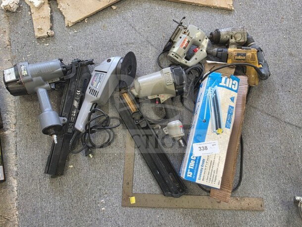Lot of miscellaneous power tools, including nail guns, drills, and an angle grinder. Condition unknown. Sold as is.