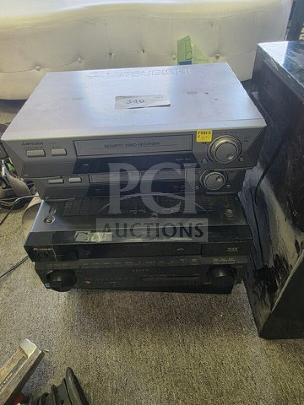 Lot of miscellaneous electronics including a Mitsubishi videocassette recorder, sold as is. Visible wear on devices.