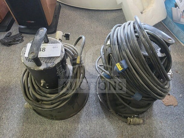 A pair of Speedotron Universal Light Units with cables, showing signs of use, sold as is.