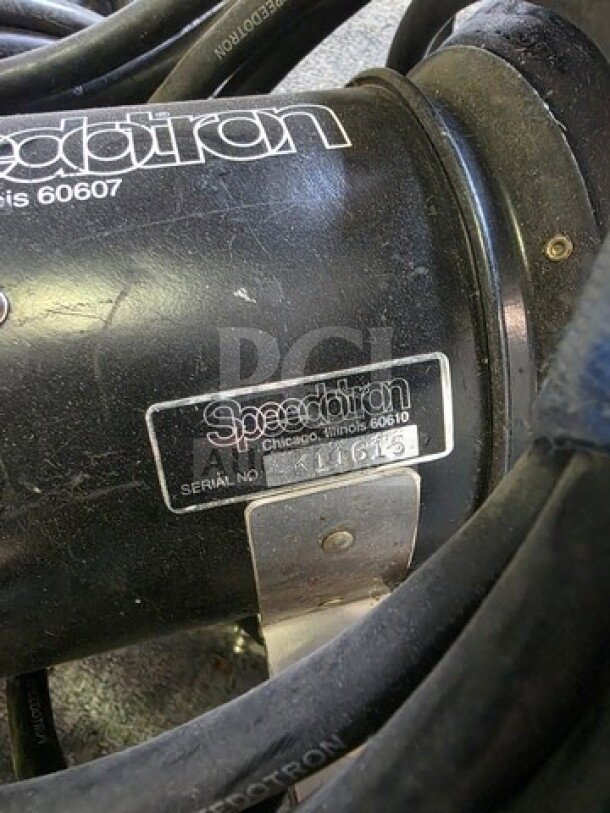 A pair of Speedotron Universal Light Units with visible serial number K11615. Sold as is, showing wear on the casing.
