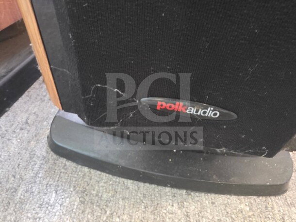 Polk Audio LSi15 Tower Speaker close-up showing base and logo, visible wear and dust, sold as is.