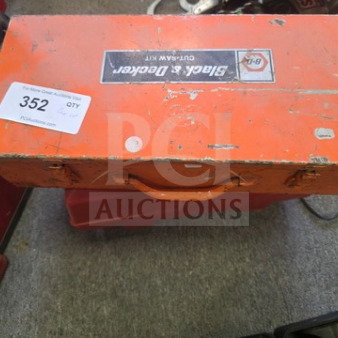 Orange Black & Decker tool box with handle, scuffed surface, labeled "OUT-SAW KIT." Auction tag "352" visible.