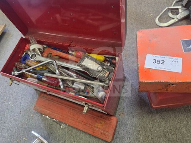 Red metal toolbox filled with various hand tools including wrenches, screwdrivers, and a tape measure. Includes label "352 QTY."