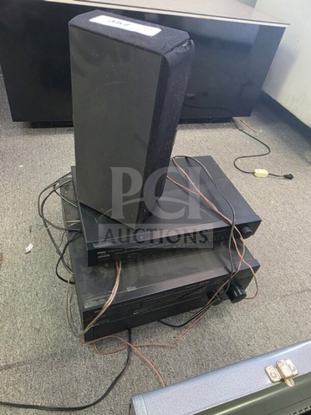 Lot of miscellaneous electronics including speakers and stacked audio components. Visible wear, sold as is.