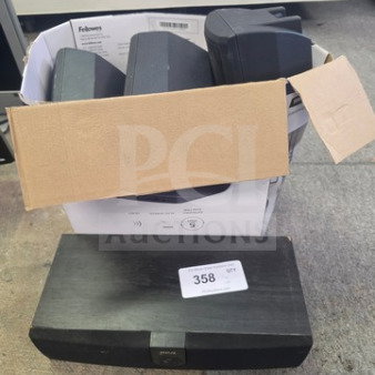 Lot of miscellaneous electronics, including speakers in a cardboard box and a labeled black electronic device. Moderate condition.