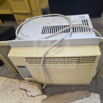 Window air conditioner, off-white, with control panel on the side. Visible wear and power cord attached. Sold as is.