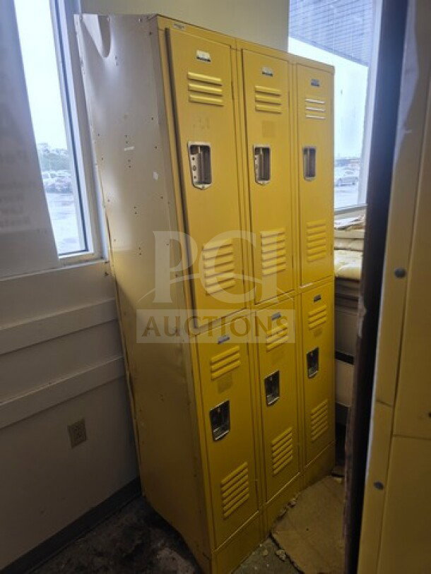 Yellow lockers, six doors, metal construction, visible wear. Sold as is. Ideal for storage purposes.