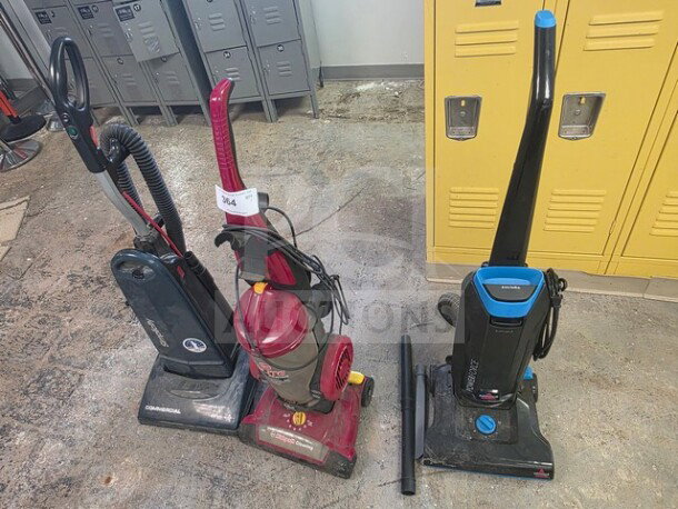 Lot of 3 vacuum cleaners, various brands and models, sold as is. Visible wear and dirt. Includes upright and canister types.