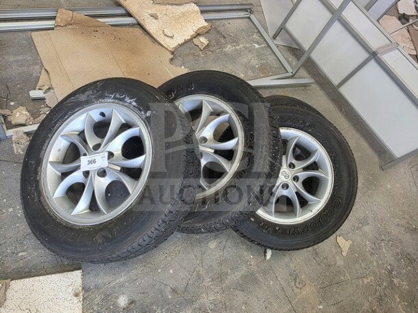 Lot of four Good Year P195/70R15 tires with alloy rims. Used condition with visible wear. Sold as is.
