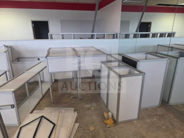 Lot of aluminum-framed glass display counters, various sizes, and shapes. Used condition. Ideal for retail or exhibitions.