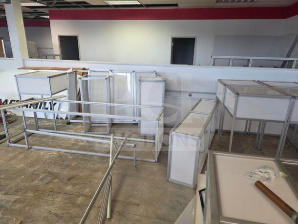 Lot of miscellaneous aluminum-framed glass display counters, various sizes, disassembled, in used condition.