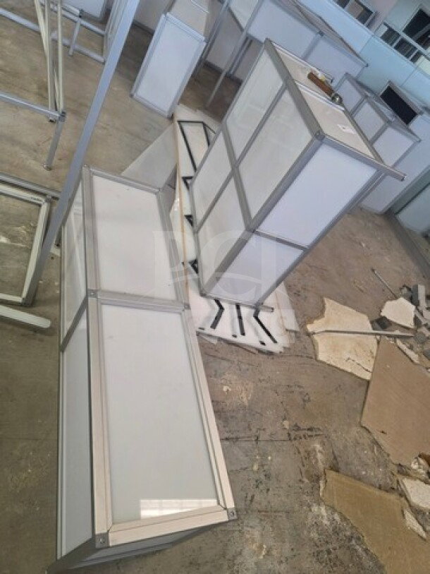Lot of miscellaneous aluminum-framed glass display counters, varying sizes. Some visible wear, suitable for retail use.