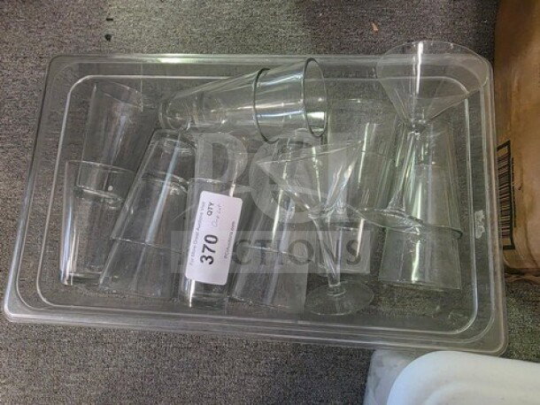 Lot of assorted glasses in a plastic tray, including martini and tumbler styles. Auction label reads "Lot 370."
