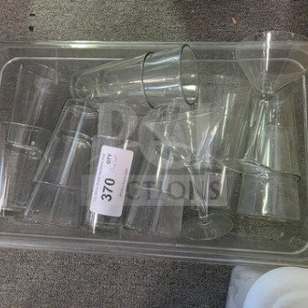 Lot of assorted glasses in a plastic tray, including martini and tumbler styles. Auction label reads "Lot 370."