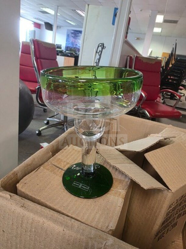 One lot of green-rimmed margarita glasses, clear glass, pristine condition, stacked in cardboard box, suitable for parties.