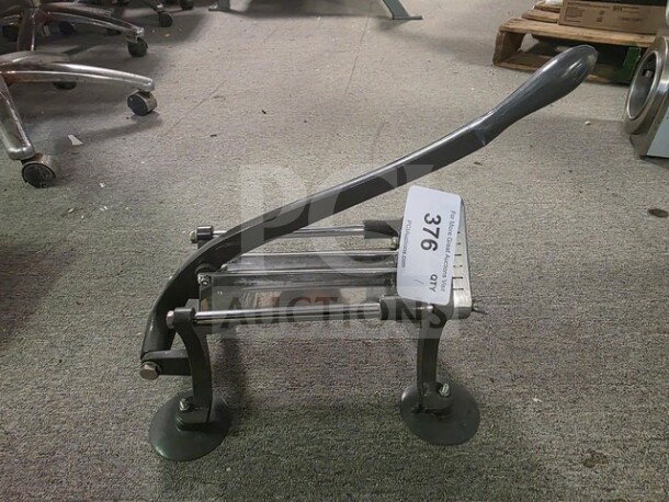 Commercial French fry cutter with lever handle, suction feet; item tag reads "Qty 376". Good condition on carpeted floor.