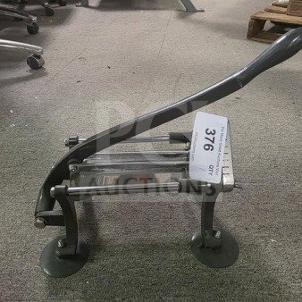 Commercial French fry cutter with lever handle, suction feet; item tag reads "Qty 376". Good condition on carpeted floor.
