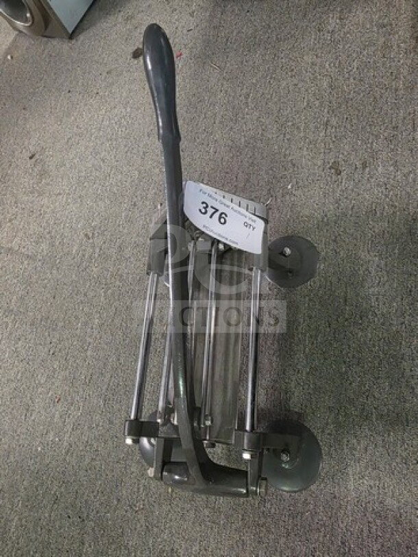 Commercial French fry cutter with sturdy metal frame, long handle, and grid blades. Shows minor wear. Auction tag marked "376".