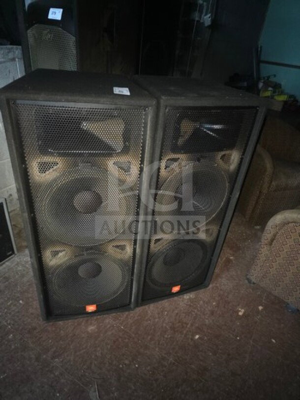 Lot of 2 JBL JRX125 dual 15-inch passive speakers, black. Visible wear. Sold as is.