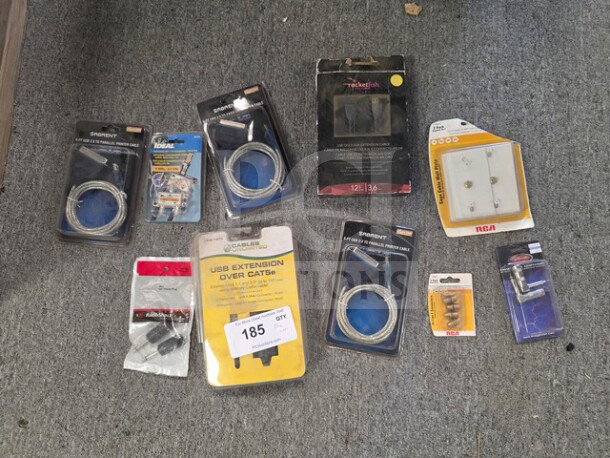 Lot of miscellaneous cables and adapters, including brands like Sabrent and RCA, in original packaging. Assorted types and conditions.
