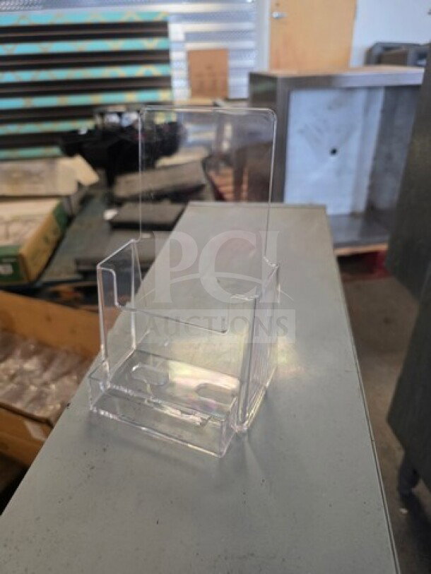 Clear acrylic brochure and business card holder in good condition, showcases a sleek design for office or retail display.