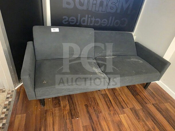 Gray fabric couch with signs of wear and stains, sold as is. Simple design with wooden legs. Condition denotes use.