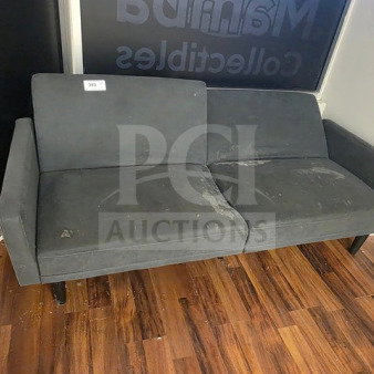 Gray fabric couch with signs of wear and stains, sold as is. Simple design with wooden legs. Condition denotes use.