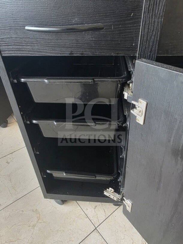Lot of 4 black salon trolleys with three slide-out trays and a lockable cabinet. Good condition, ideal for organizing salon tools.