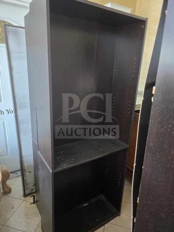 Lot of 3 bookcases, dark wood finish, adjustable shelves, visible wear and scuffs, suitable for storage or display.