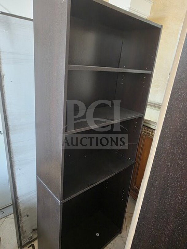 Lot of 3 black wooden bookcases, each with four adjustable shelves. Visible wear, suitable for home or office use.