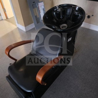 Black shampoo chair backwash unit with wooden armrests, integrated sink, excellent condition. Ideal for salon use.