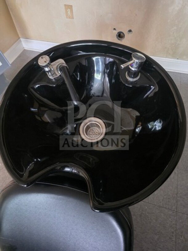 Black shampoo chair backwash unit with integrated sink and faucet. Good condition, ideal for salon use.