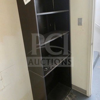 Lot of 2 tall black bookcases, four shelves each, used condition with visible wear.