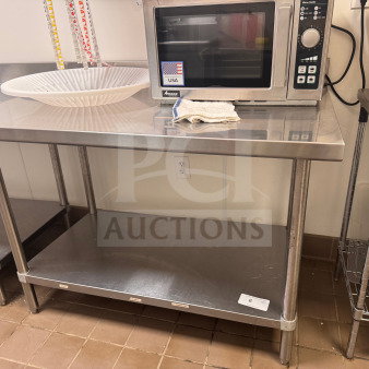 48" stainless steel kitchen work table with backsplash, two-tier design. Features durable construction, ideal for commercial use.