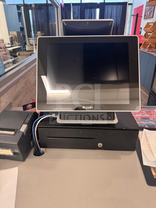 POS system with cash drawer, three receipt printers, and payment terminal. Untested, sold as-is. Includes power cables and cords.
