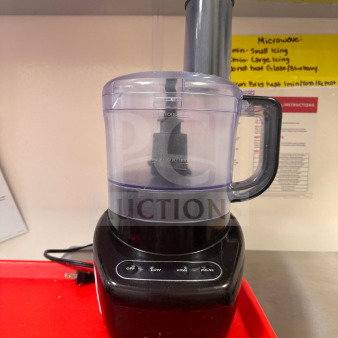 Black food processor with a clear container, working condition, controls labeled Off, Low, High, Pulse, minor cosmetic wear.