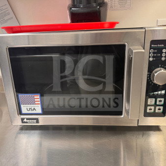 Amana Commercial Microwave Oven in excellent condition with minimal wear. Features dial controls and labeled "Fabricated in the USA."