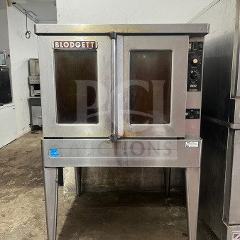 Blodgett BDO-100-G-ES convection oven with dual glass doors on metal stand, showing wear. Brand and model labels visible.