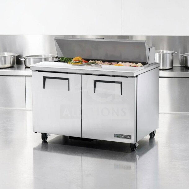 True TSSU-48-12-HC prep table in top-tier condition; 48-inch refrigerated base; 115V; stainless steel; tested operational.