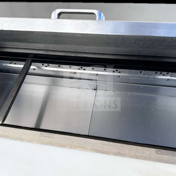 "True TSSU-48-12-HC prep table interior, stainless steel, top-tier condition, handle visible, 48-inch refrigerated base."