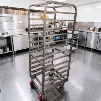 Commercial stainless steel bun pan rack, heavy-duty, mobile with red wheels, superior condition, fully operational.