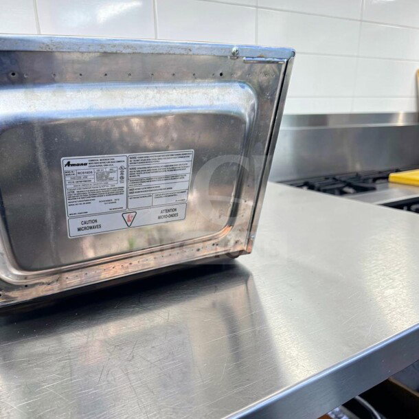 Amana RCS10DS commercial microwave oven in stainless steel, 1000W, medium volume, model tag visible. Exceptional condition.