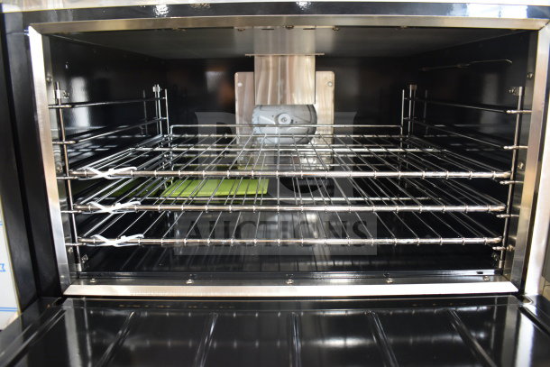 Interior view of a brand new Imperial IR-6-G24-CC convection oven, showcasing clean, shiny metal racks and spacious cooking area.