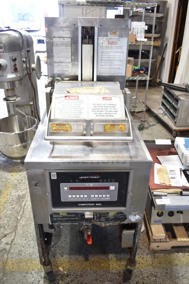 Henny Penny PFG-690 Computron 8000 pressure fryer, natural gas, 100,000 BTU, on casters, with control panel and safety labels.